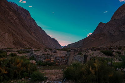 Scenic view of mountains against blue sky