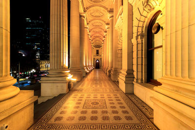 Front of illuminated victoria state parliament historic building