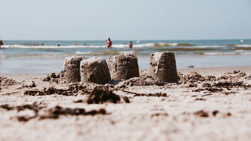 Man standing on beach against clear sky