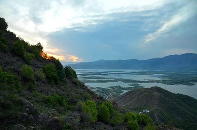 Scenic view of mountains against cloudy sky