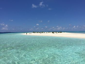 Scenic view of sea against blue sky