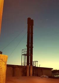 Factory against sky at sunset