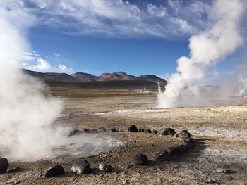 Smoke emitting from volcanic mountain against sky