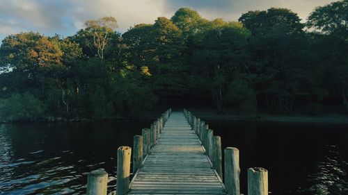 Pier over lake against sky