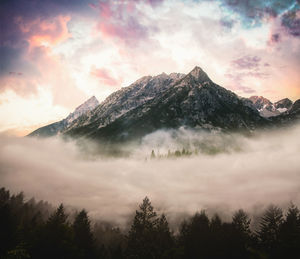 Scenic view of mountains against cloudy sky