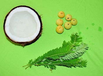 High angle view of fruits and leaves on table