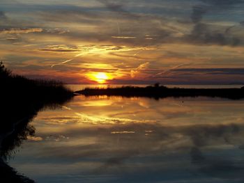 Scenic view of sunset over lake