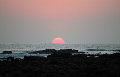 Scenic view of sea at sunset