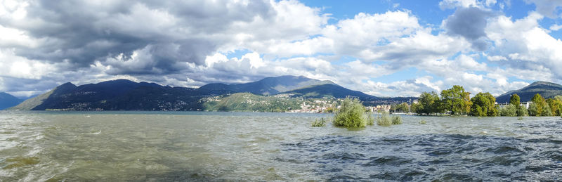 Panoramic view of sea and mountains against sky