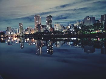 Reflection of illuminated buildings in city at night