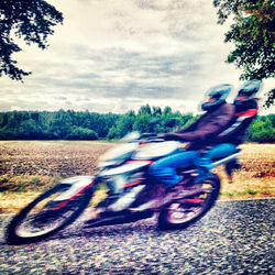 Person riding motorcycle on road