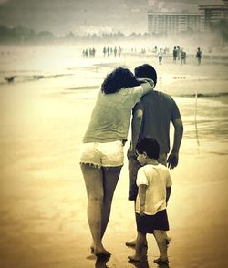 Rear view of couple standing on beach