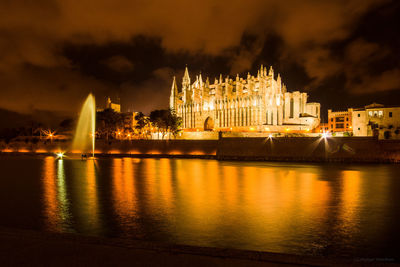 Fountain lake, illuminated cathetral against sky at night, palmade mallorca 