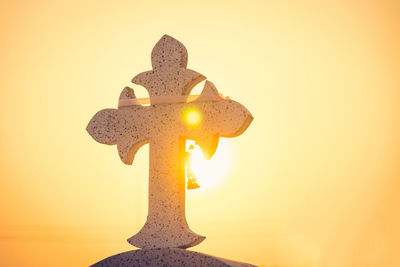 Close-up of illuminated lamp against sky during sunset