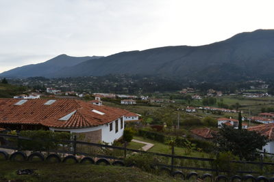 High angle view of houses in town against sky