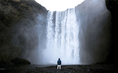 Scenic view of waterfall against sky