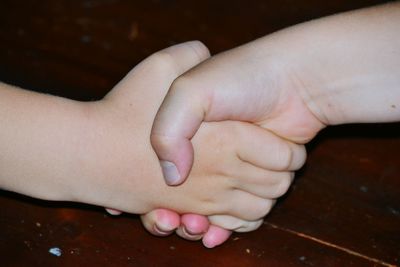 Cropped image of friends shaking hands