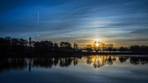 Scenic view of lake against sky during sunset