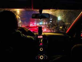 Rear view of man driving car