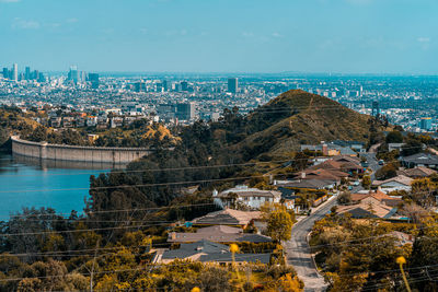 Aerial view of buildings and trees against sky