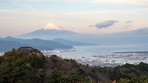 Scenic view of sea and mountains against sky