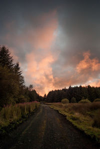 Road amidst landscape against sky during sunset