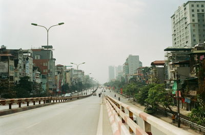 City street and buildings against sky