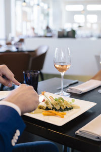 Close-up of man eating food in restaurant