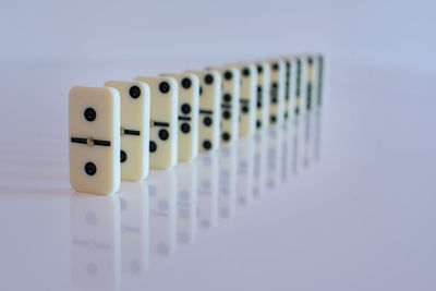 High angle view of piano keys on table against white background