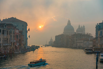 View of buildings against cloudy sky during sunset