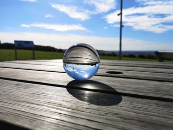 Close-up of crystal ball on wooden table