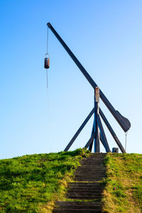 Low angle view of windmill on field against clear sky