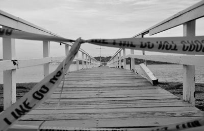 Cordon tape against bridge over lake