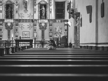 Woman sitting on pew at church