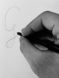 Close-up of person hand holding pencil