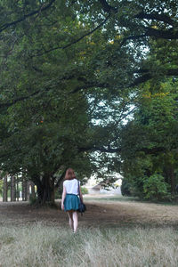 Rear view of woman standing on field