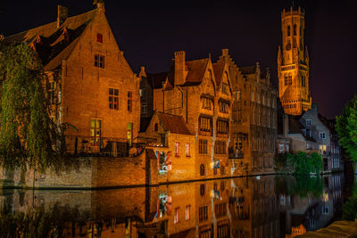 Reflection of illuminated buildings in water at night