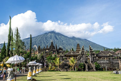 Panoramic view of temple and buildings against sky