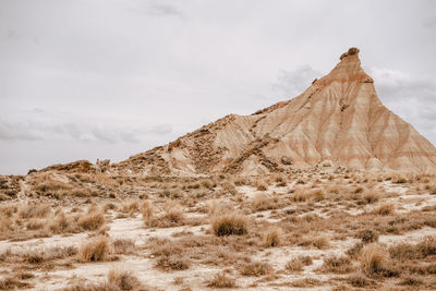 Scenic view of arid landscape against sky