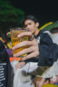 Midsection of a woman drinking glass