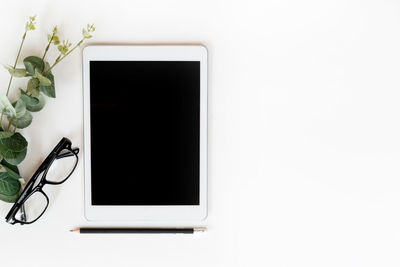 Directly above shot of white and laptop on table