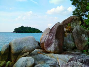 Rocks on beach against sky