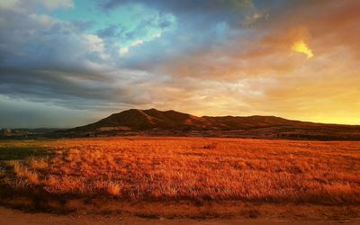 Scenic view of landscape against cloudy sky