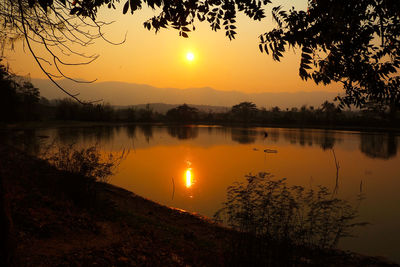 Scenic view of lake against sky during sunset