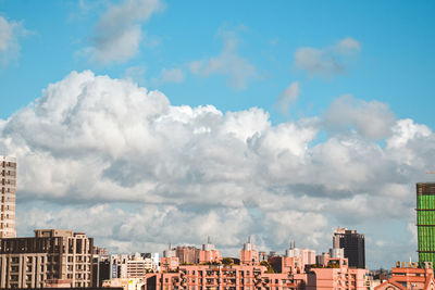 Buildings in city against sky