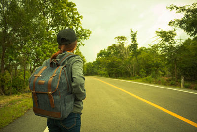 Rear view of man standing on road