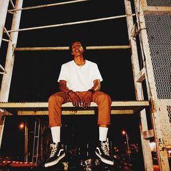 Portrait of young man sitting outdoors