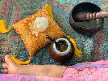 High angle view of hand holding bowl on table