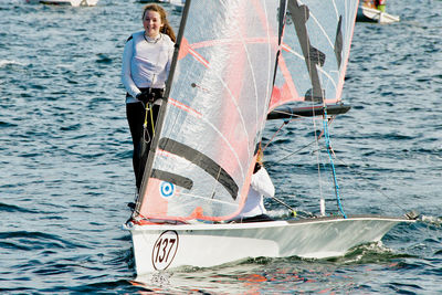 Man sailing on sailboat in sea