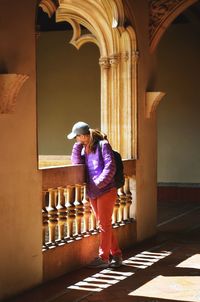 Full length of woman standing in corridor